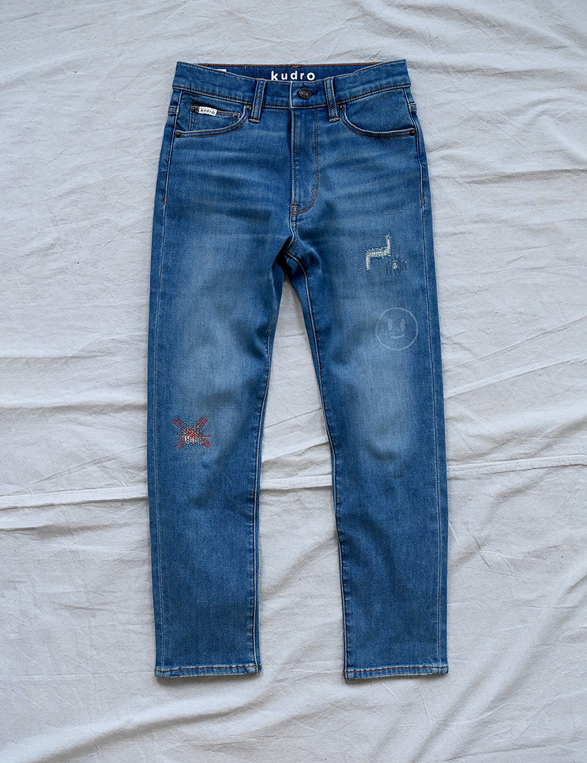 Kudro Kids The Repair Skinny leg denim jeans front with unique design elements including embroidered and scuffed patch