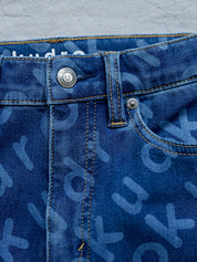 The Kudro straight leg denim jeans with unique pattern, up close image of button closure