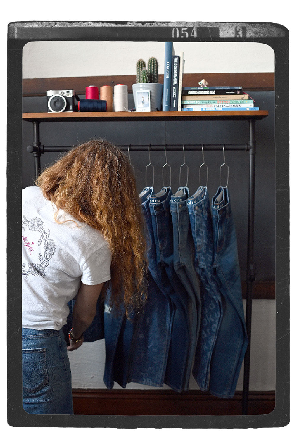 Rebecca Ford sorting Kudro Kids jeans collection on clothing rack