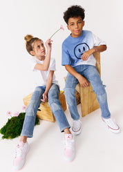 kudro kids utility straight boy and girl siting on wooden apple boxes with flowers