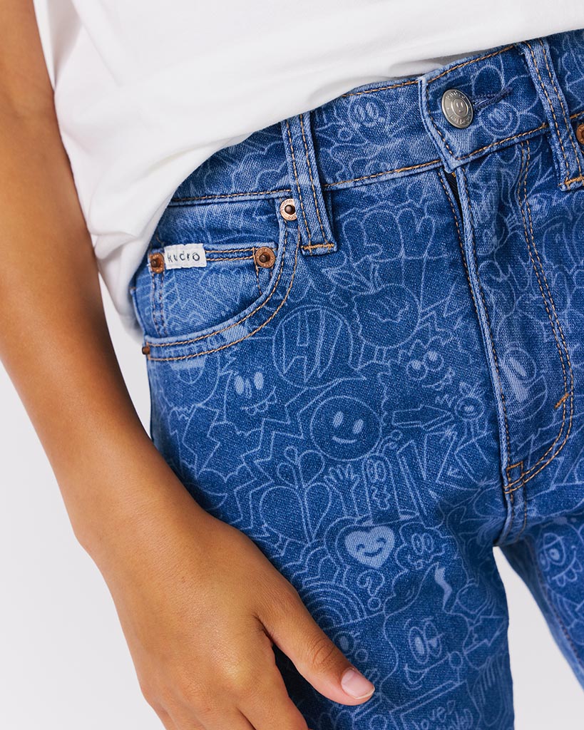 kudro kids wotto skinny jean with graphic ddodle print close up image showing coin pkt and button detail