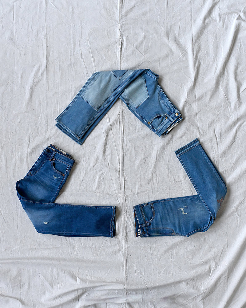 Kudro Kids denim jeans organised in shape of recycle symbol