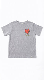 Gray t-shirt with a red heart graphic wearing sunglasses and riding a skateboard on a white background