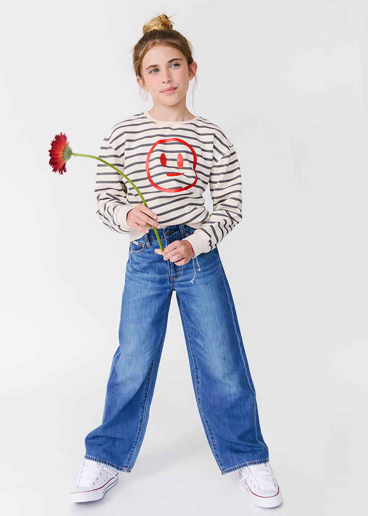 kudro kids wide leg jean front full shot on girl model holding flower